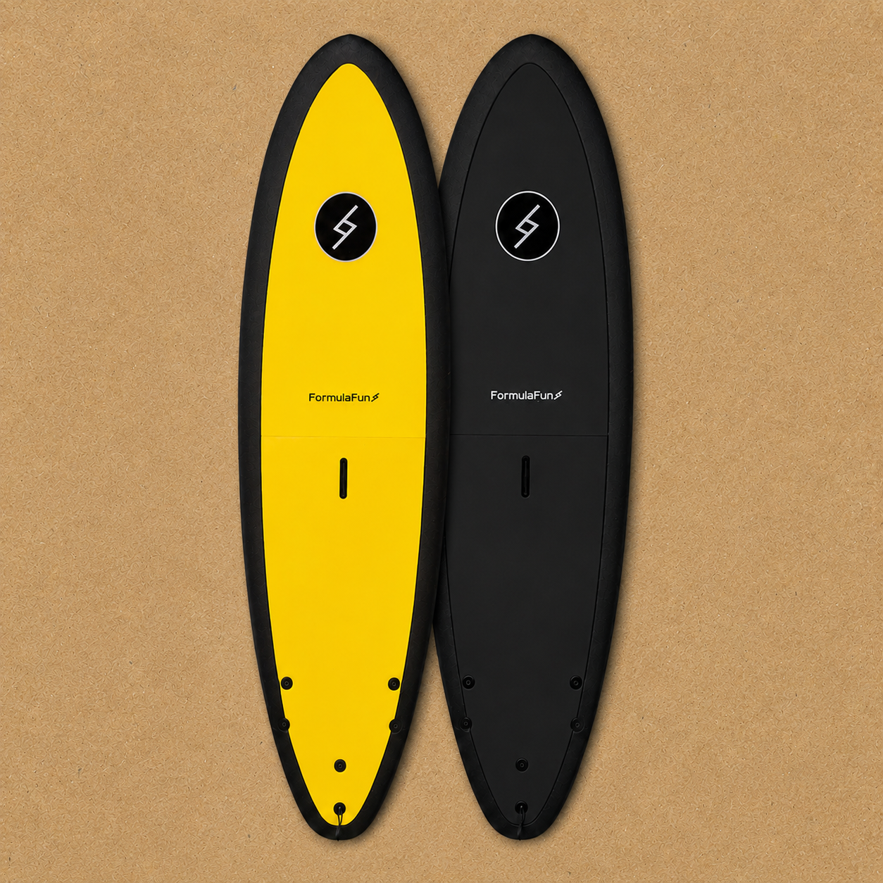 Yellow and black Formula Fun 6'0" Jam foam surfboards on a tan textured surface