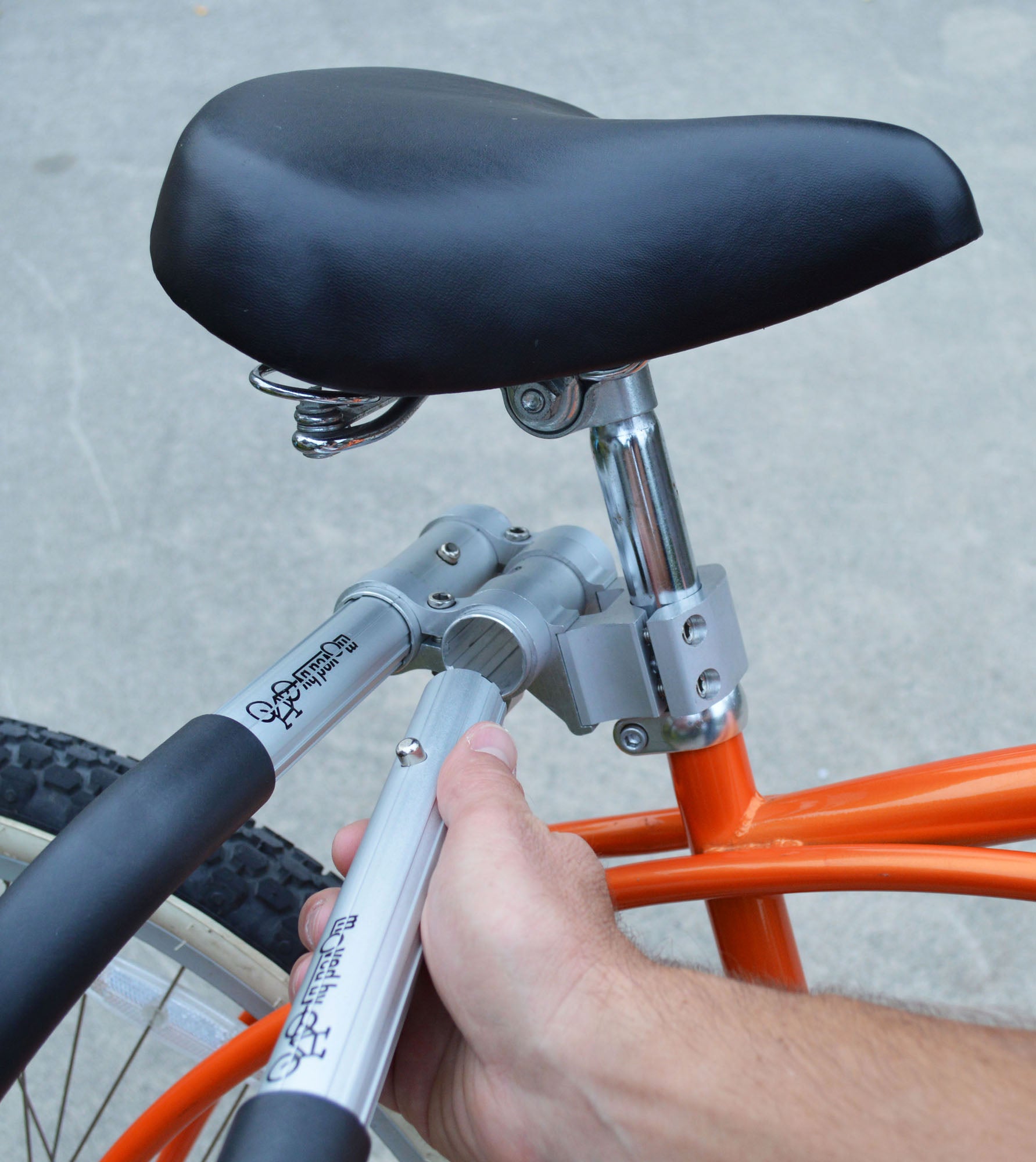 An orange bike with a seat mount for an MBB surfboard rack