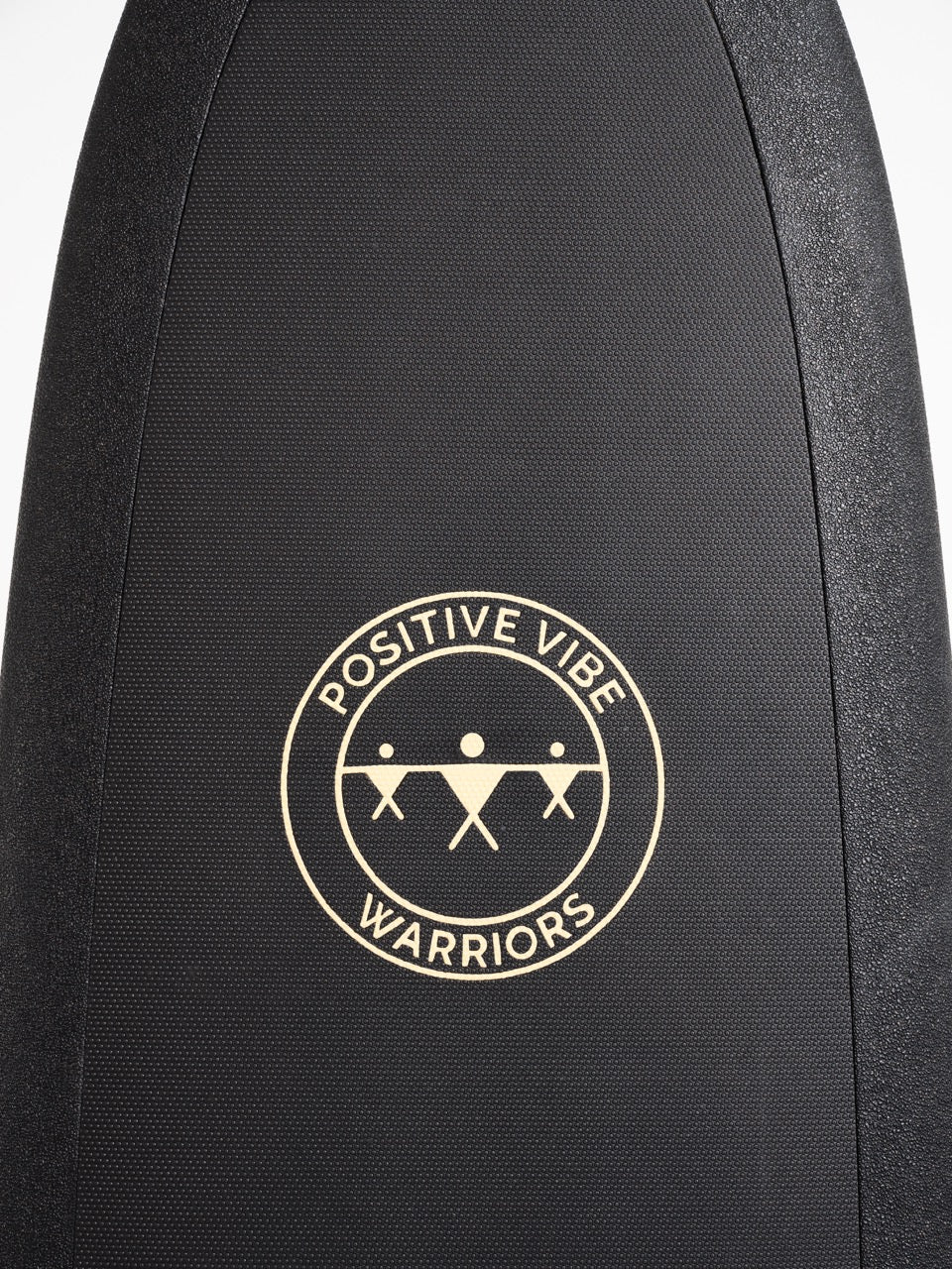 The front wax free deck pad of a black 8 foot Positive Vibe Warriors Scout surfboard with a logo on a white background