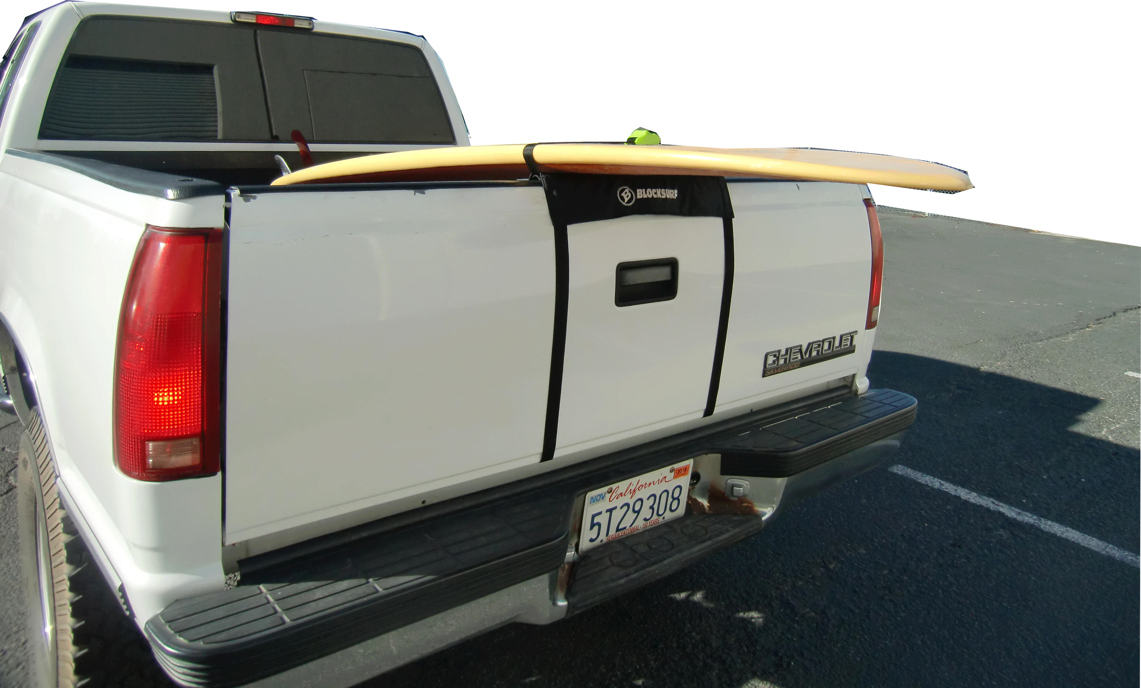 White truck with a Tailgate Rack Pad keeping a yellow surfboard off the tailgate