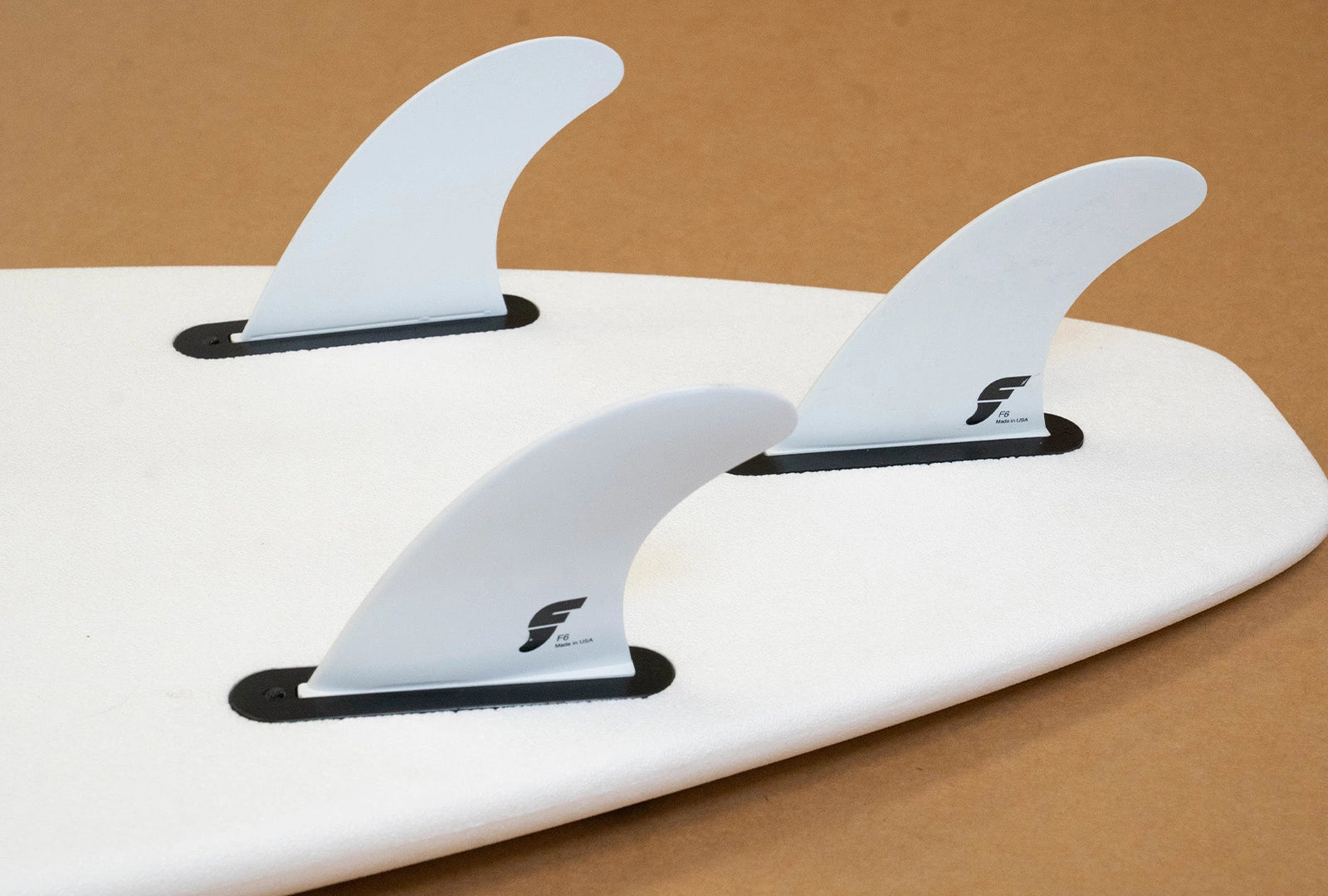 A Formula Fun Zippers surfboard with a thruster fin set up from Futures Fins