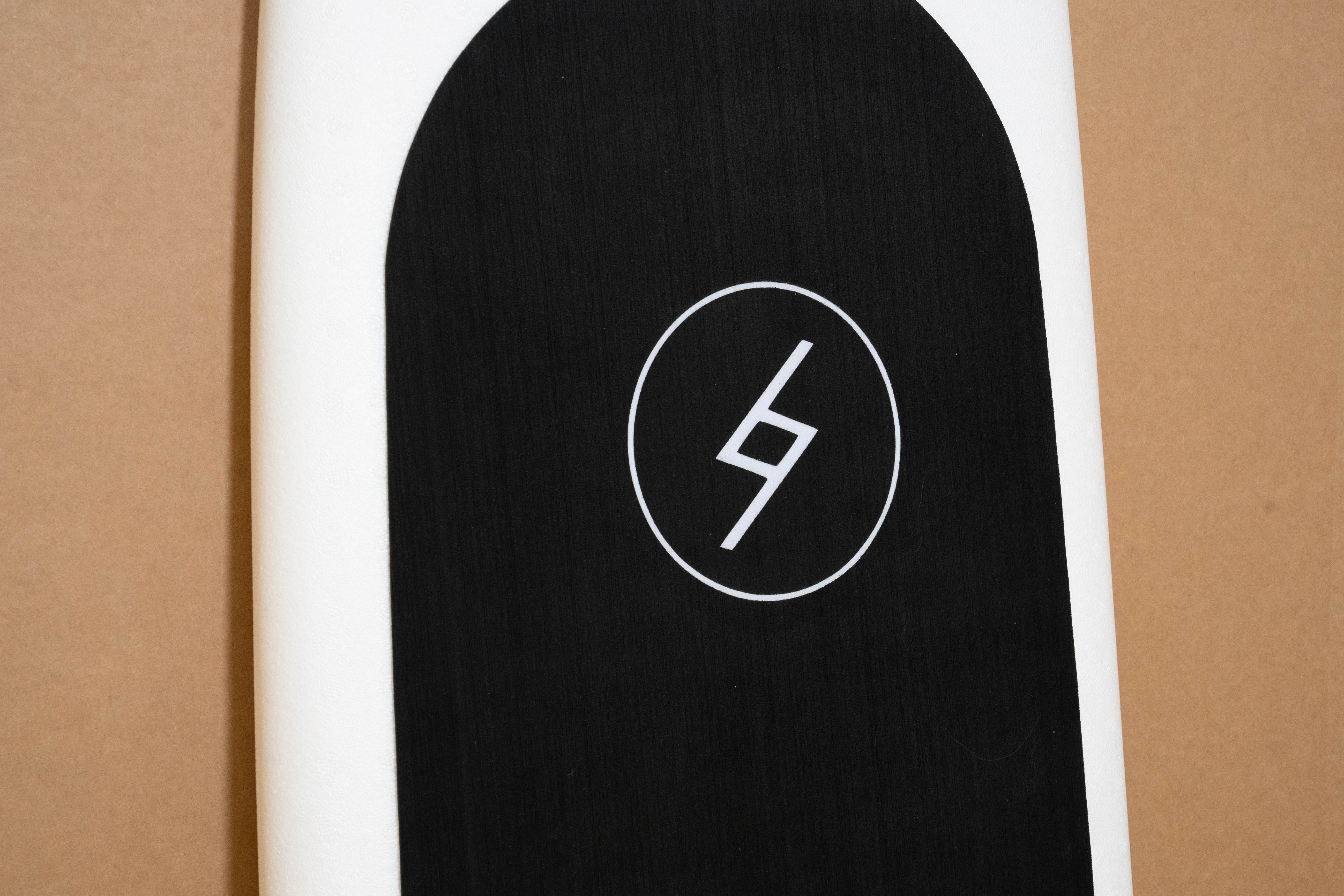 Black Formula Fun Foamies logo on a 6 foot 4 inch white Zipper surfboard